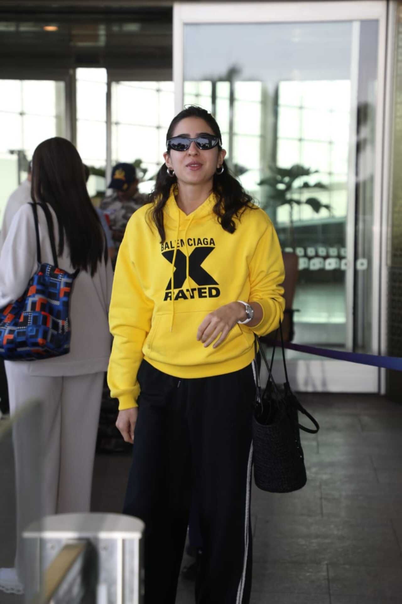 Sara Ali Khan was seen in a travel mode as she was spotted at the airport in a yellow hoodie and black track pants paired with sunglasses.